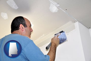 a contractor spackling drywall - with Alabama icon