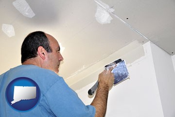 a contractor spackling drywall - with Connecticut icon