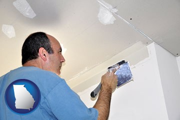 a contractor spackling drywall - with Georgia icon