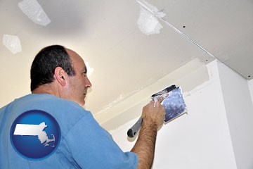 a contractor spackling drywall - with Massachusetts icon