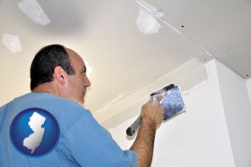 a contractor spackling drywall - with New Jersey icon