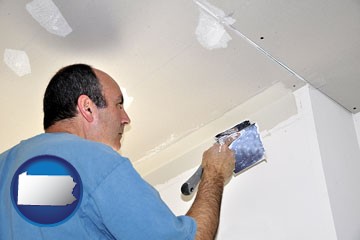 a contractor spackling drywall - with Pennsylvania icon