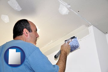 a contractor spackling drywall - with Utah icon